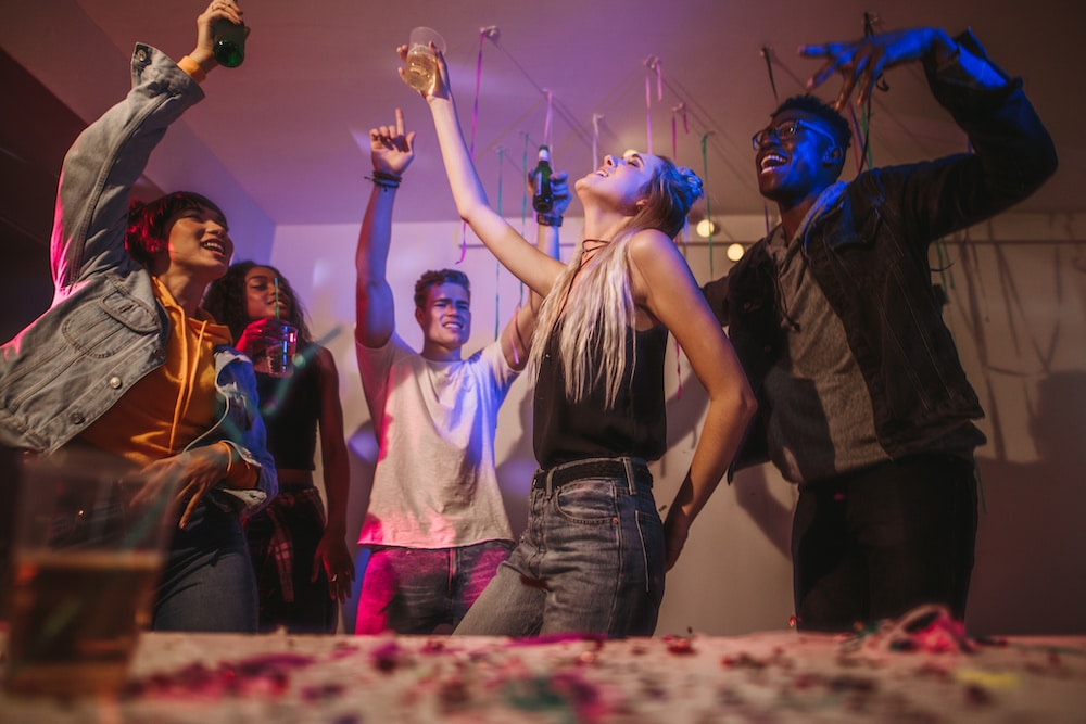 House party with decorations and people dancing.