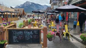 Graze Food & Drink outdoor seating area with menu board and background view of the mountains