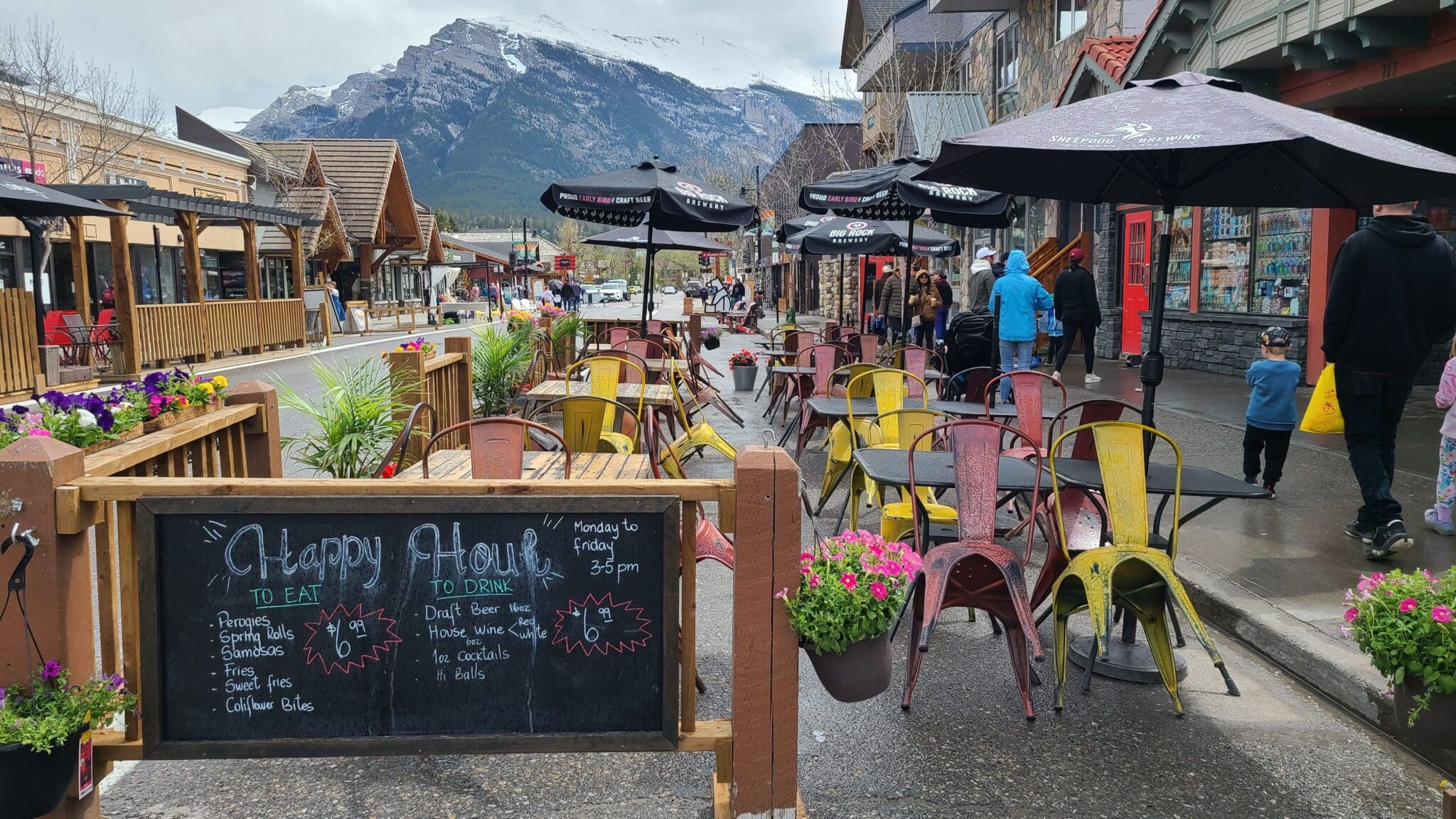 Graze Food & Drink outdoor seating area with menu board and background view of the mountains
